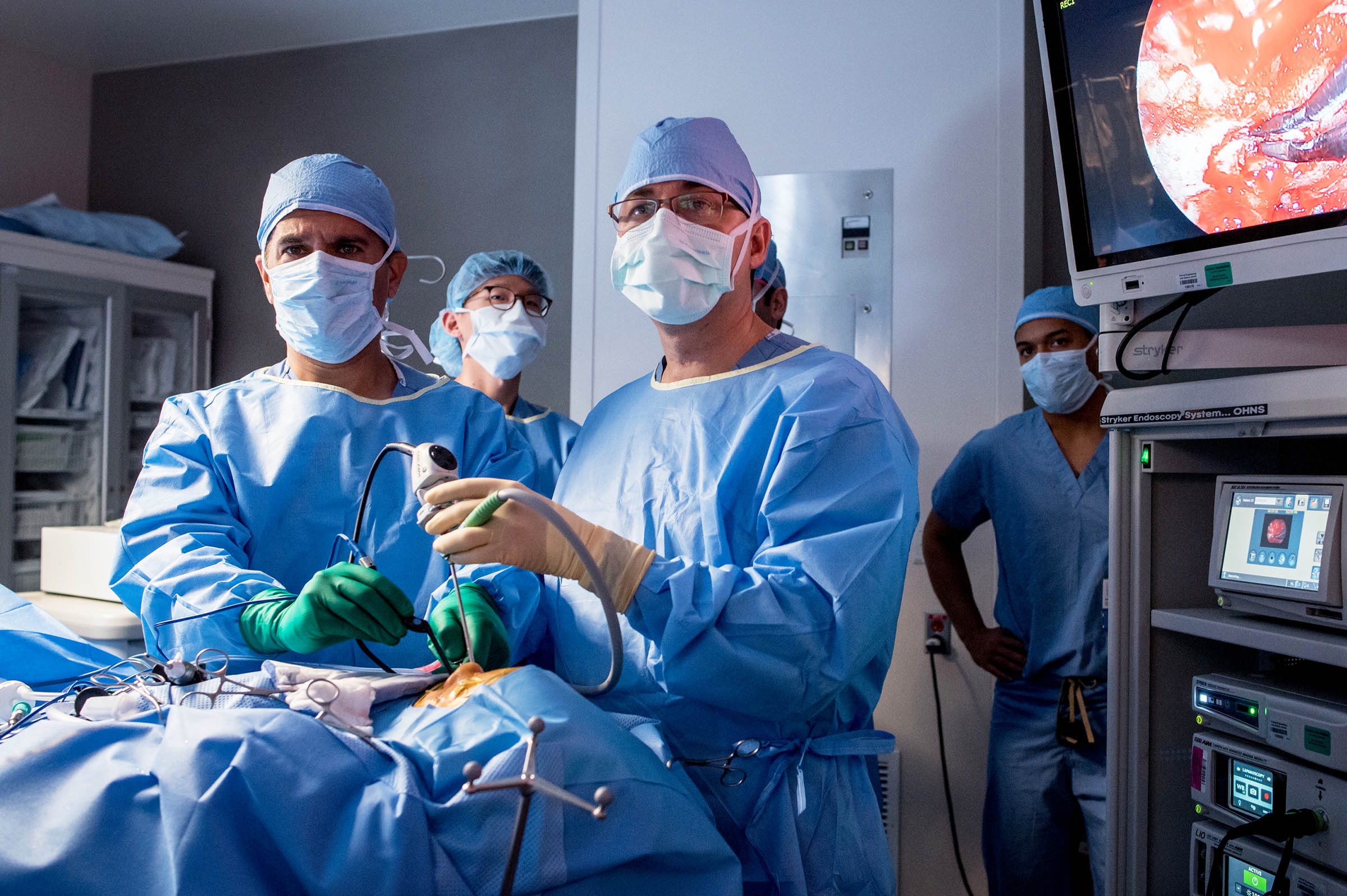 brain surgery in bangalore, group of doctors doing surgery based on appear on monitor